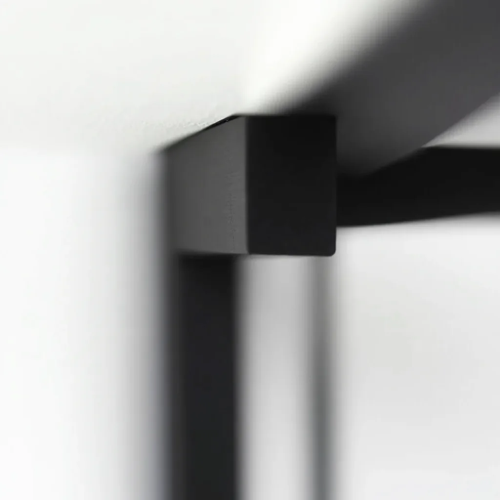 Close-up detail of matte black steel frame corner joint showing powder-coat finish quality and solid construction